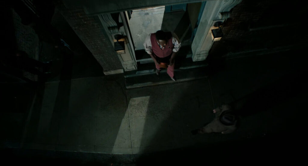 Lonnie exiting Robbie's apartment building.
