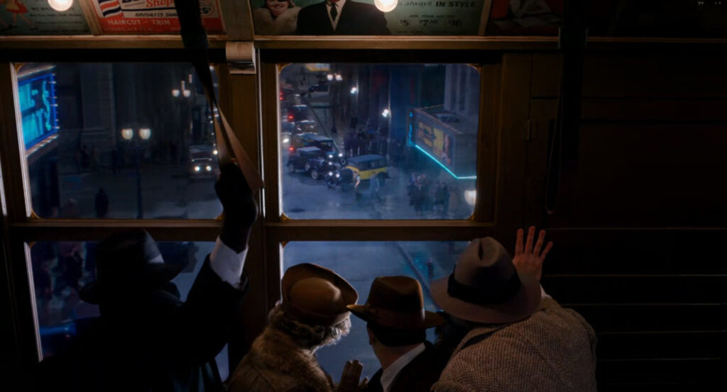 Onlookers from a passing L Train watch a fight on the street between Leyden and The Spider.