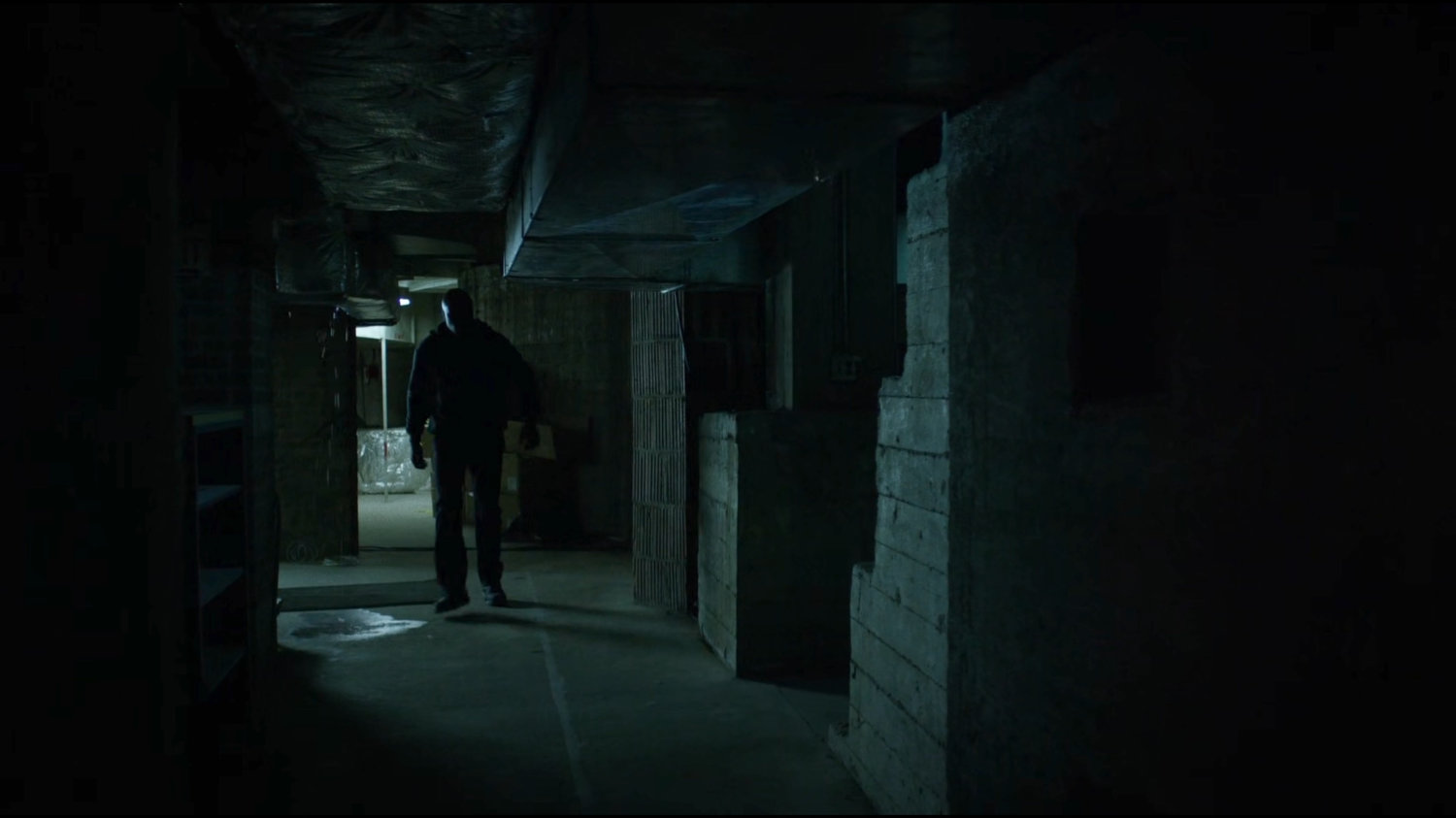 Luke walking through a basement hallway of Harlem's Paradise.