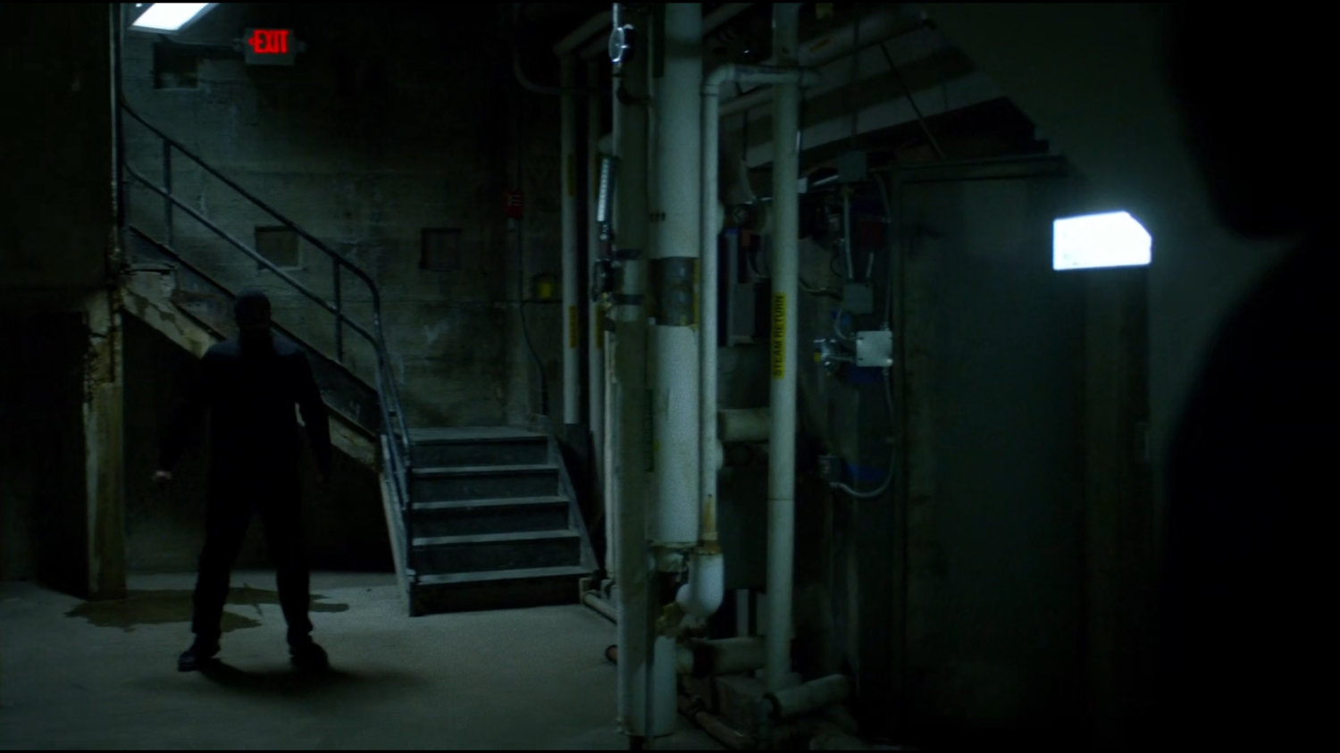 Luke walking through a basement hallway of Harlem's Paradise.