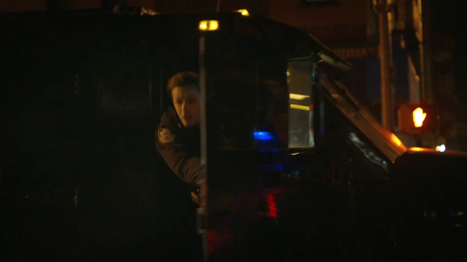 Officer jumping out of the paddy wagon.