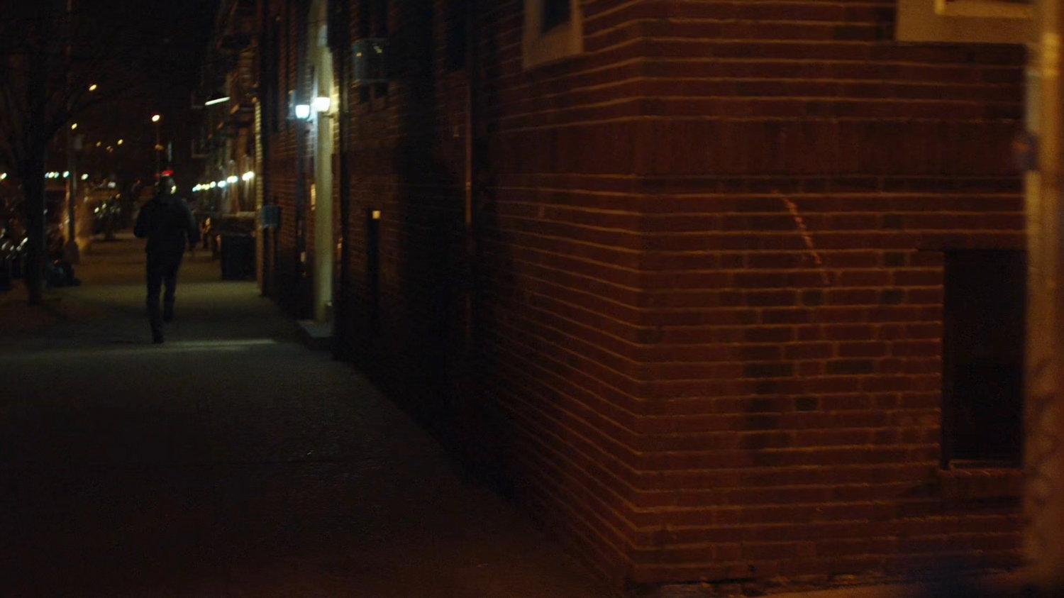 Luke running down a sidewalk away from the officers.