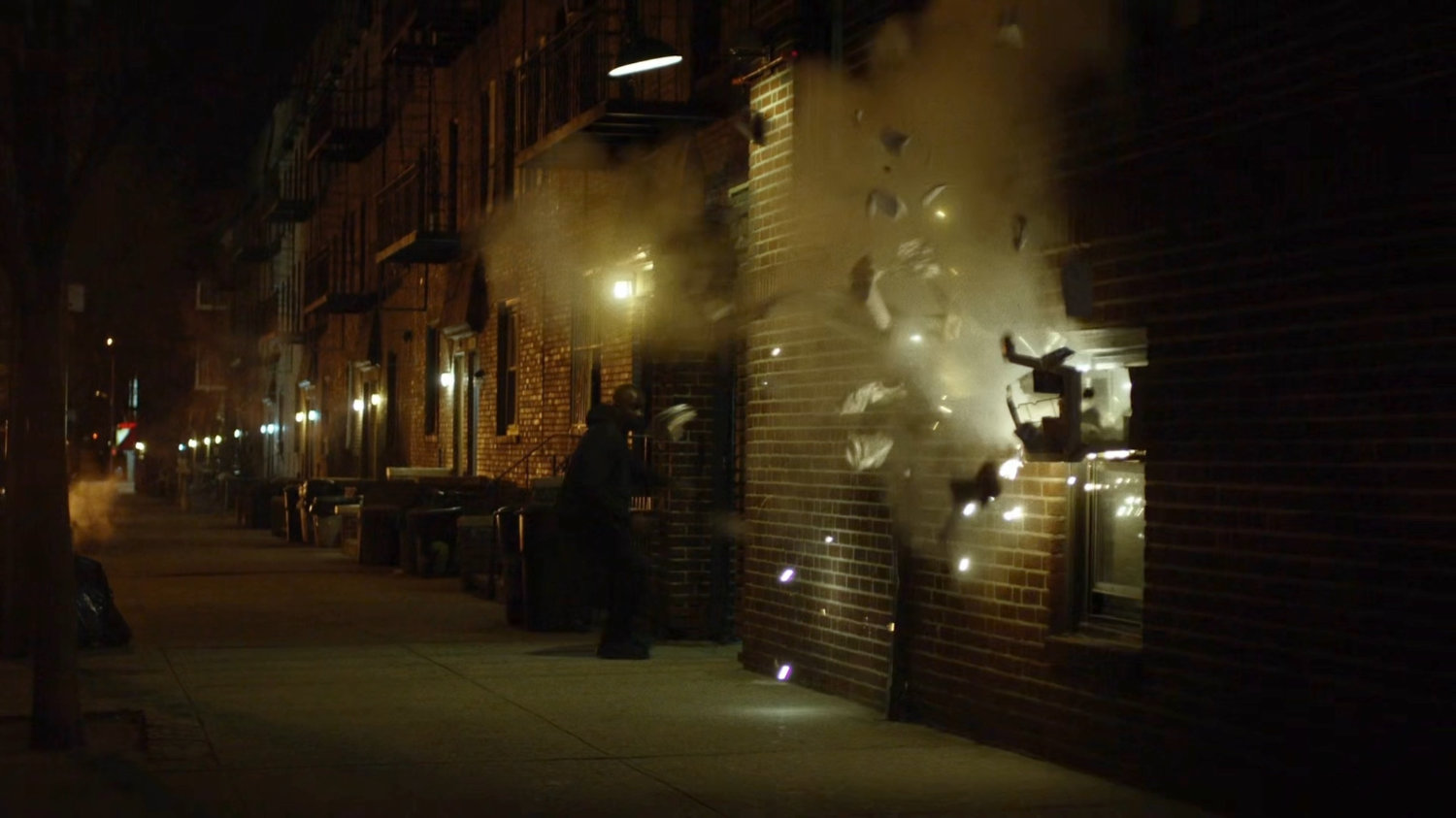 Gunfire erupting around Luke on a sidewalk.