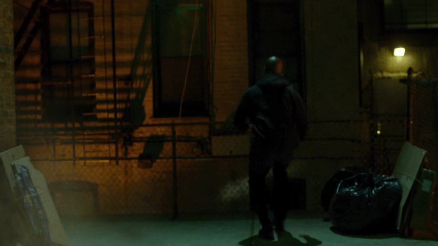 Luke running through an alley.