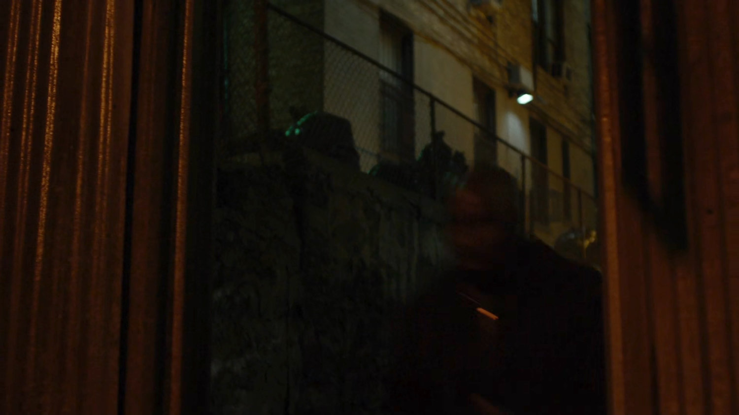 Luke running through an alley.