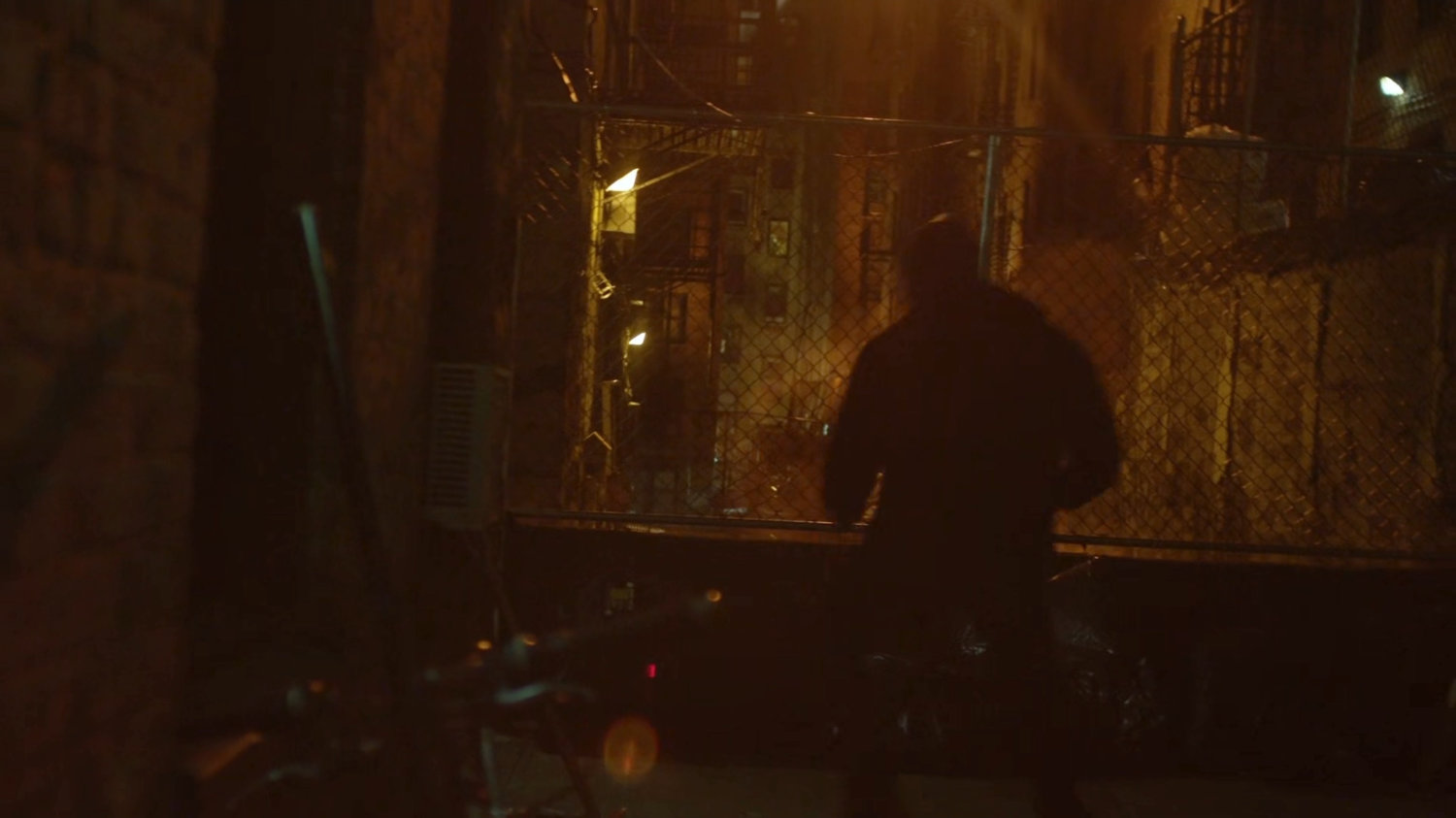 Luke running through an alley.