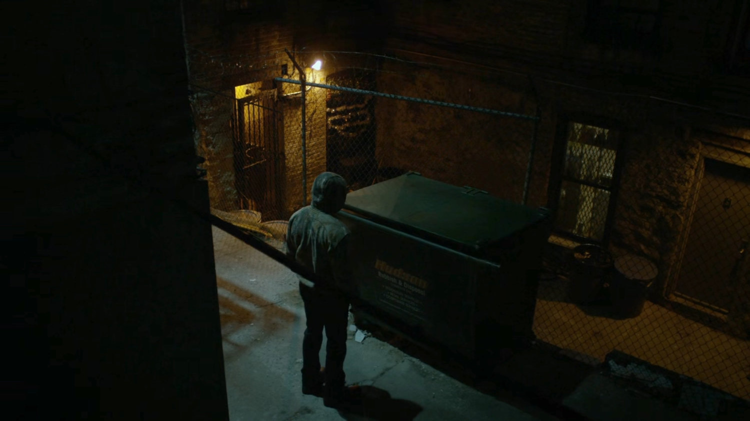 Luke puts Turk in a dumpster in a dark alley.