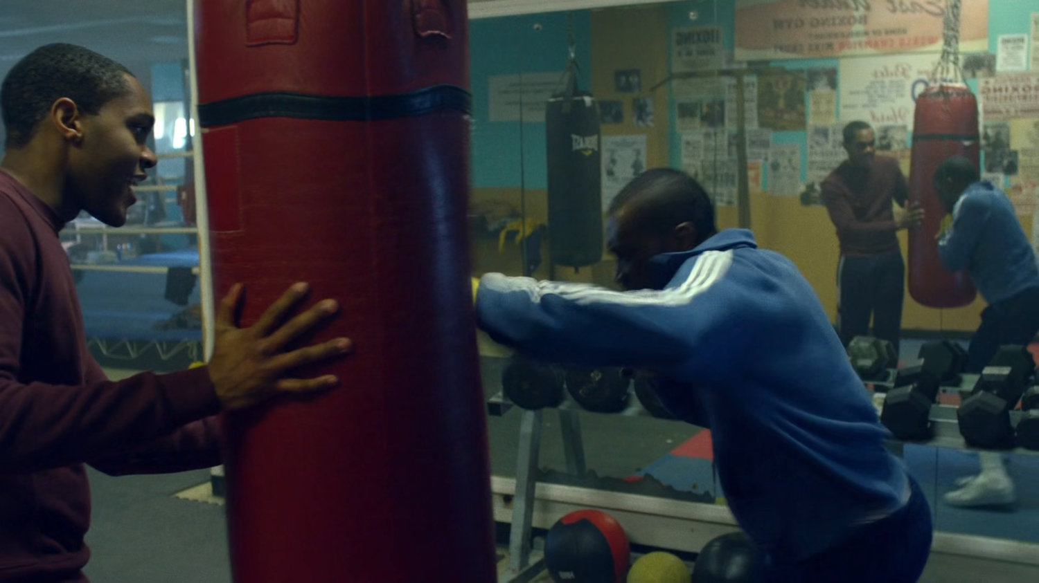 Young Willis and young Carl sparring in a boxing gym.