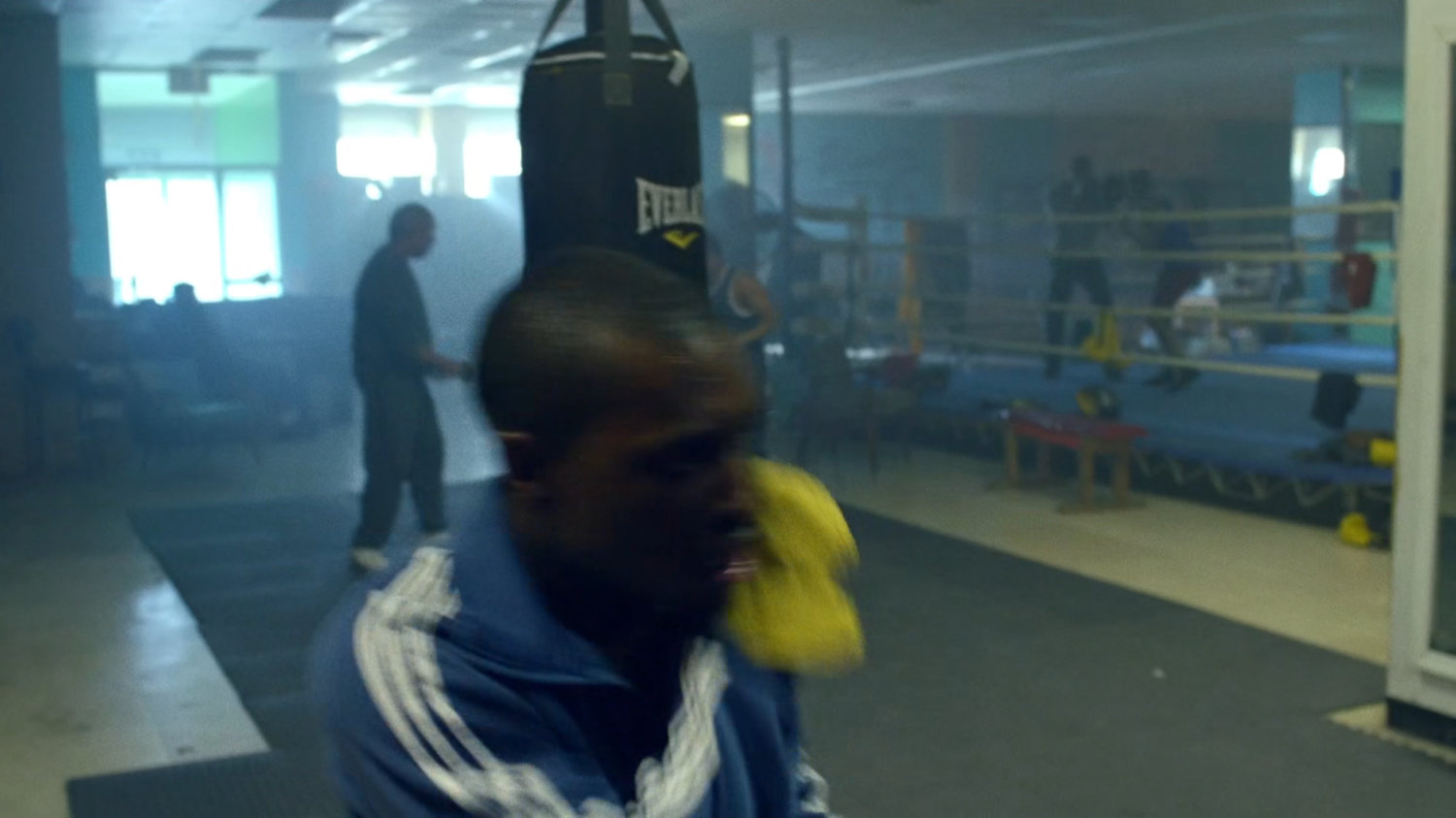 Young Carl sparring in a boxing gym.