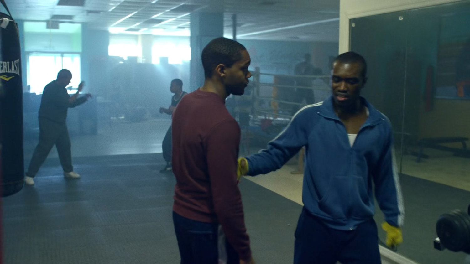 Young Willis and young Carl sparring in a boxing gym.