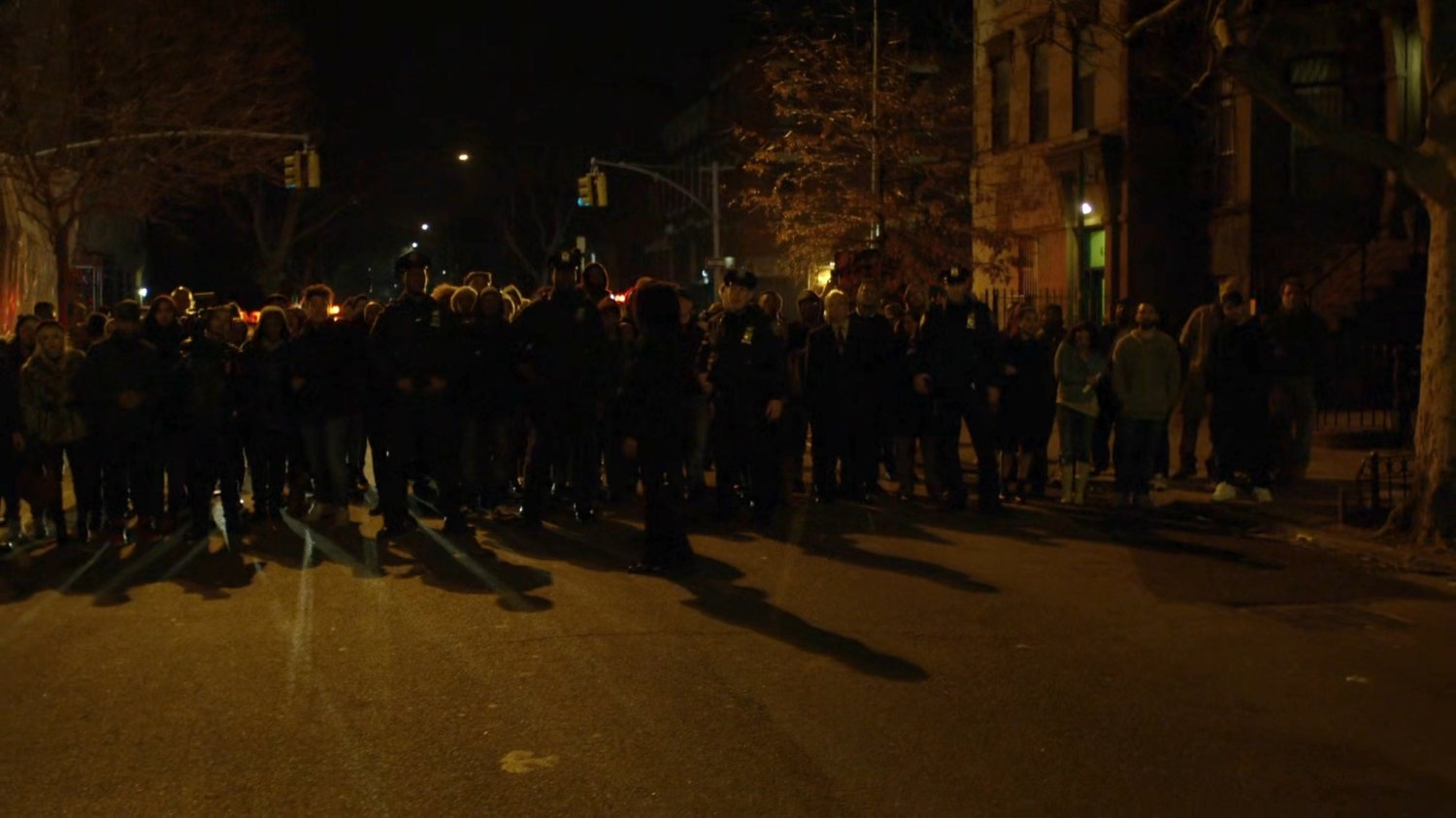 A crowd on a dark Harlem street.