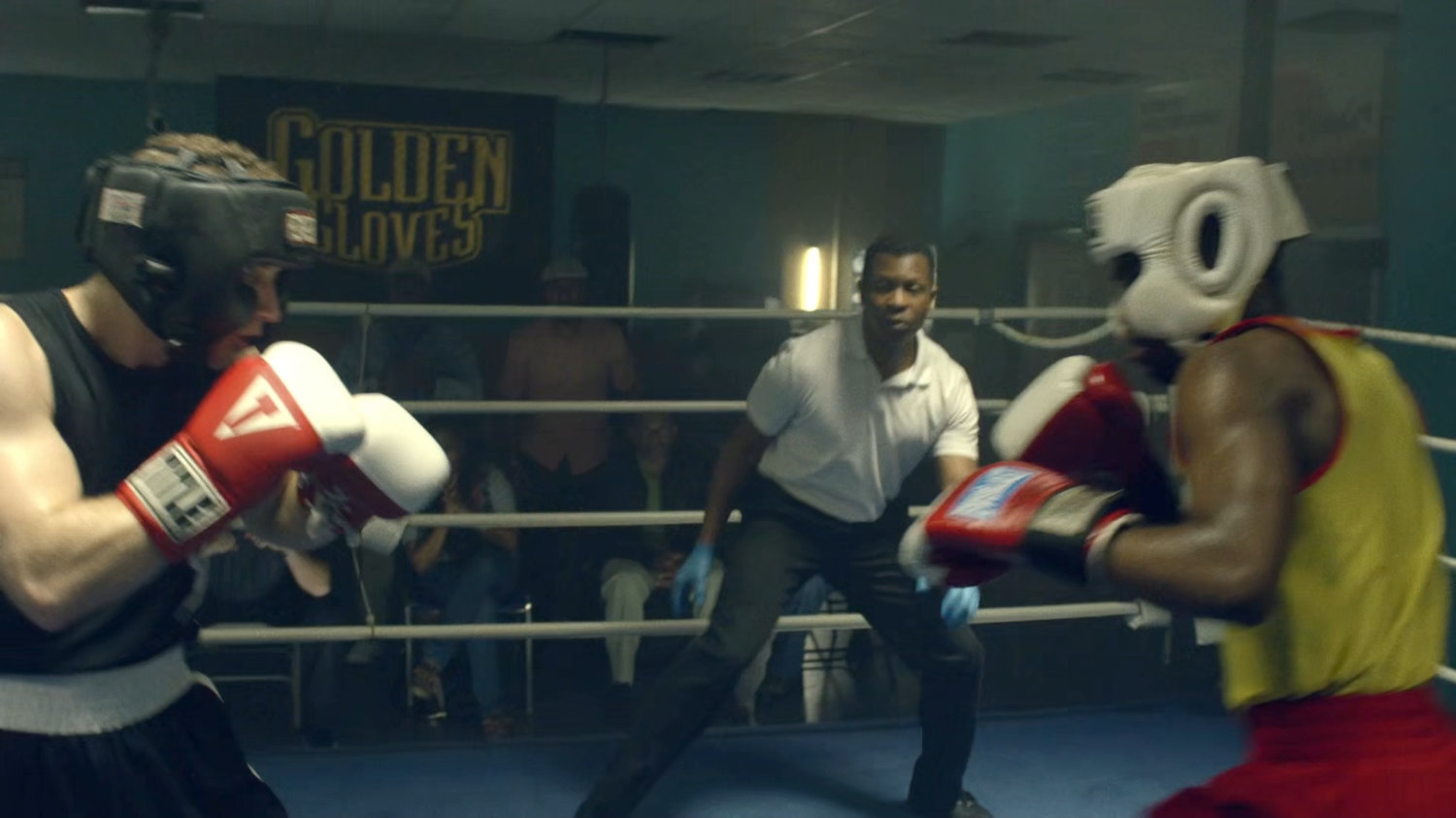 Young Carl and another teenager sparring in a boxing gym.